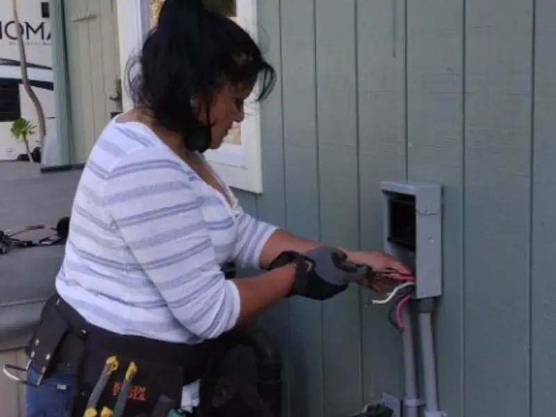 Licensed electrician wiring an exterior subpanel in Kaysville